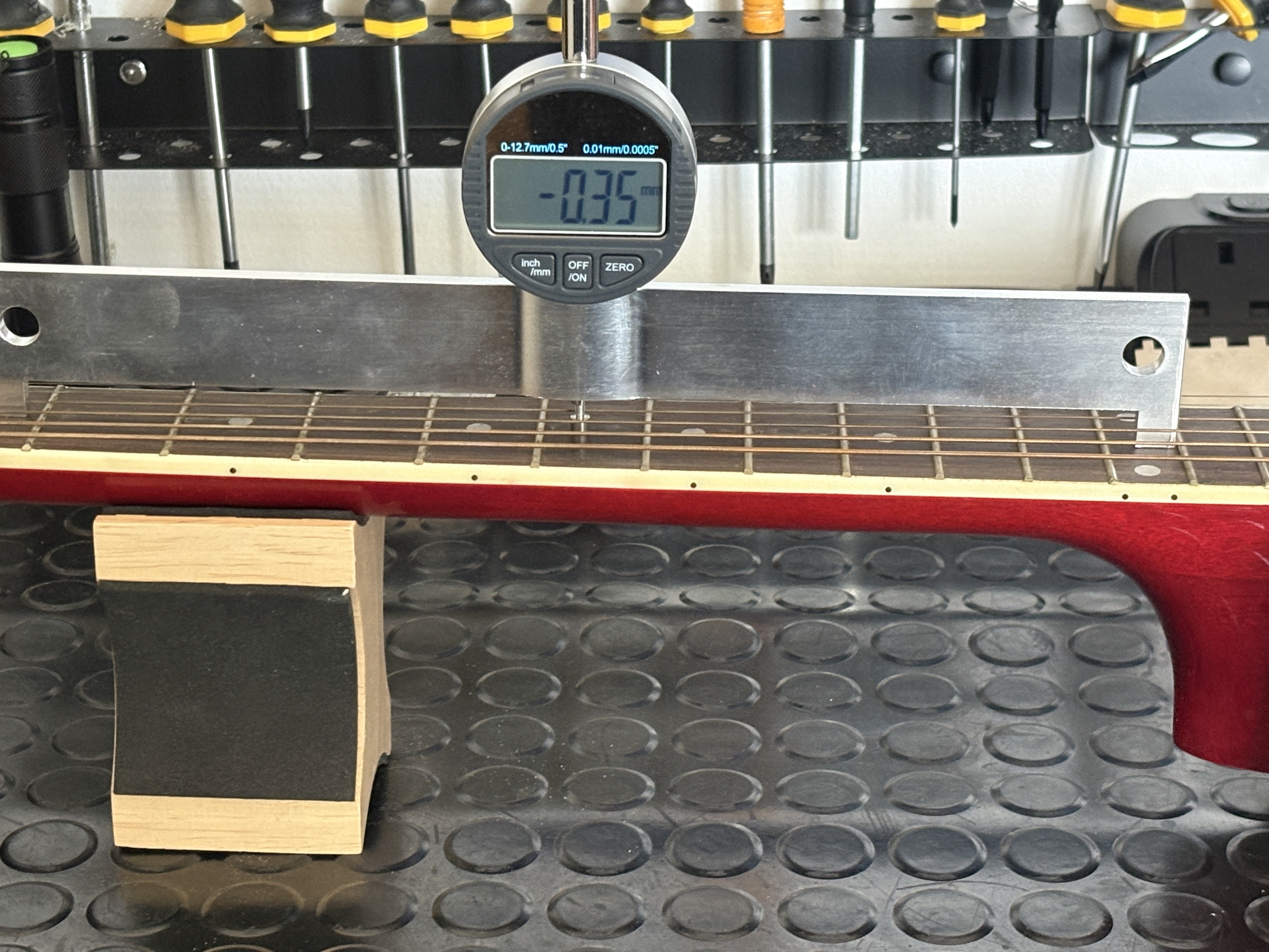 Neck relief adjustment using digital gauge for precision
